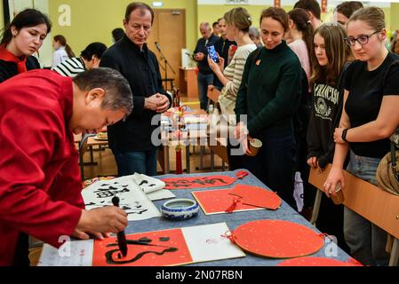 Moskau, Russland. 3. Februar 2023. Studenten sehen einen Künstler, der chinesische Kalligraphie schreibt, um das chinesische MondNeujahr am Konfuzius-Institut der russischen Staatsuniversität für Geisteswissenschaften in Moskau, Hauptstadt Russlands, am 3. Februar 2023 zu feiern. Kredit: Cao Yang/Xinhua/Alamy Live News Stockfoto