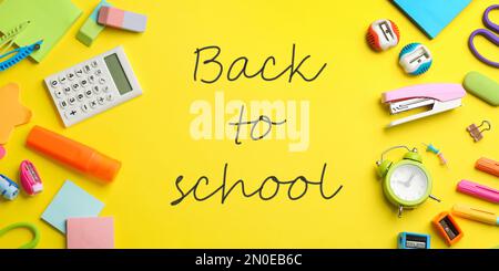 Text Back to School und anderes Schreibwaren auf gelbem Hintergrund, flach liegend. Bannerdesign Stockfoto