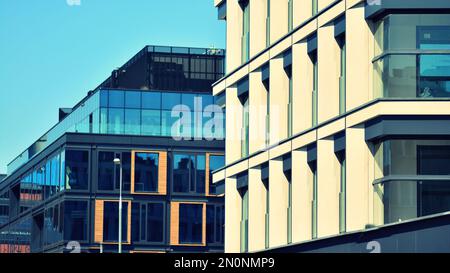 Moderne Fassade eines Bürogebäudes Abstraktes Fragment, glänzende Fenster in Stahlkonstruktion, Retro-stilisierter Farbfilter Stockfoto