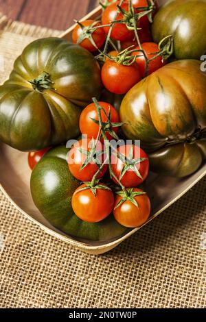 Ein ruhiges Leben mit köstlichen reifen Tomaten auf Leinentüchern Stockfoto