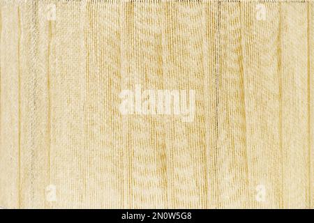 Gepolsterte Oberfläche mit dickem cremefarbenen Fadengewebe. Struktur des Stoffhintergrunds Stockfoto