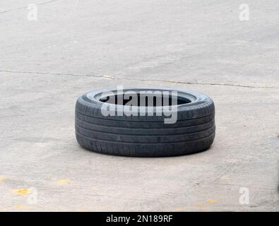 Gebrauchte Lkw-Reifen liegen auf Betonstraßen, Kfz-Transportservice. Stockfoto