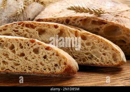 Leckeres, frisch gebackenes Brot auf einem Holztisch, Nahaufnahme Stockfoto