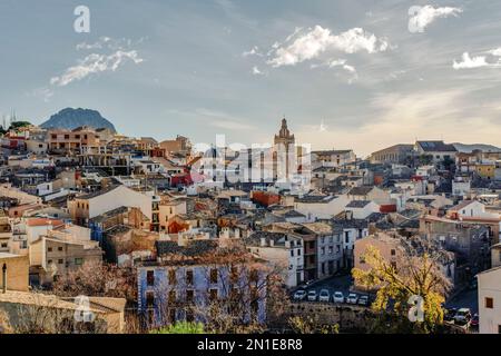 Altstadt von Relleu mit seiner historischen Kirche, alten Häusern und dem Berg Puig Campana im Hintergrund. Befindet sich in der Provinz Alicante, Spanien Stockfoto