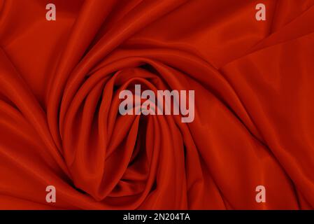 Abstrakter seidenroter Hintergrund. Luxuriöses, glattes, elegantes wellenförmiges Material Kann als Hintergrund zum Valentinstag oder anderes Design verwendet werden. Draufsicht, Bereich Kopieren Stockfoto