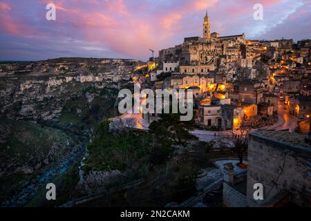 Sonnenuntergang über den antiken Höhlenbewohnungen von Matera in Süditalien. Matera, in der süditalienischen Region Basilikata, UNESCO-Weltkulturerbe. Stockfoto