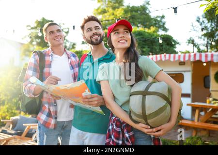 Junge Reisende mit Rucksäcken und Stadtplan planen Ausflüge im Freien Stockfoto