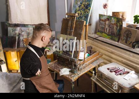 Ein Mann mit Behinderung zeichnet Bilder und engagiert sich für Kunst. Stockfoto