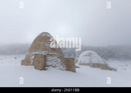 Schneegruben in Sierra Espuna, Region Murcia, Spanien, in einer verschneiten Landschaft. Es handelt sich um mittelalterliche Bauwerke aus Ziegelsteinen, die zur Lagerung von Eis verwendet wurden Stockfoto