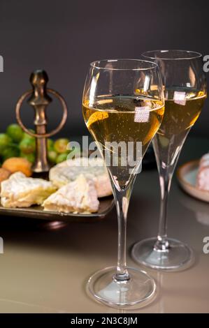Gläser Sekt oder Cava mit Sekt und französischem Weichkäse im Hintergrund, Lyon, Frankreich Stockfoto