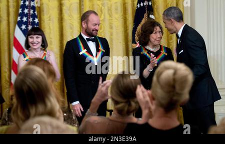 President Barack Obama, congratulates the 2014 Kennedy Center Honors Honorees, from left, ballerina Patricia McBride, singer-songwriter Sting, and comedienne Lily Tomlin, during a reception in their honor in the East Room of the White House in Washington, Sunday, Dec. 7, 2014. (AP Photo/Manuel Balce Ceneta)