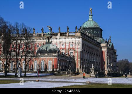 Potsdam, Deutschland. 08. Februar 2023. Im Park Sanssouci vor dem Neuen Palais sind Wanderer und Sportler im Sonnenschein und am blauen Himmel unterwegs. Auch in den nächsten Tagen bleibt es sonnig, aber mit Minustemperaturen in der Nacht. Kredit: Jens Kalaene/dpa/Alamy Live News Stockfoto