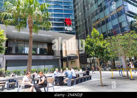 Büroumgebung und Büros am Parramatta Square, NAB-Bürogebäude mit Mitarbeitern, die während der Mittagspause draußen sitzen, Sydney, Australien Stockfoto