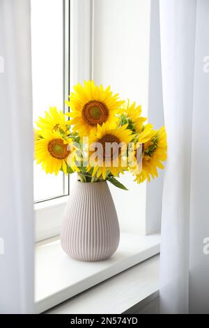 Ein Strauß wunderschöner Sonnenblumen auf dem Fensterbrett im Innenbereich Stockfoto