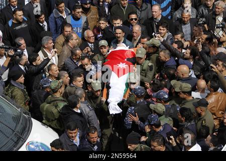Palestinians carry the body of Raed Zeiter, 38, during his funeral in