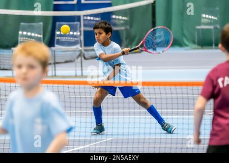 Kinder, die Tennis spielen und Tennisunterricht nehmen Stockfoto