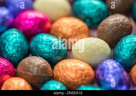 Großer Haufen bunter Schokoladeneier, glänzendes Osterkonzept, Happy easter Nahaufnahme Süßigkeiten Konzept Makro Stockfoto