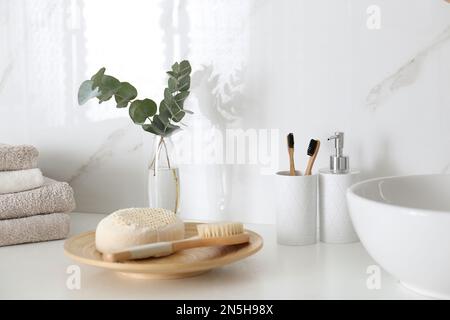 Frische Eukalyptuszweige und Badezimmerartikel auf der Arbeitsplatte Stockfoto