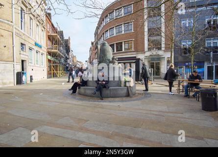 Menschen, die auf einer Gedenkfeier in Ipswich, Großbritannien, sitzen Stockfoto