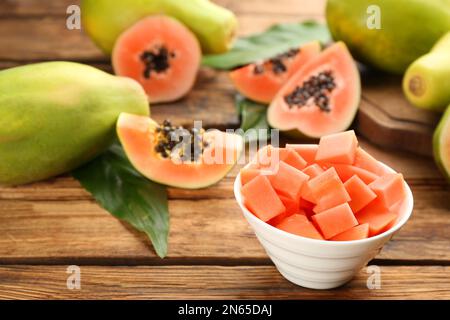 Frische gewürfelte Papaya-Früchte in der Schüssel auf einem Holztisch Stockfoto