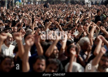 Shiite Muslims chant religious slogans during a Muharram procession, in ...