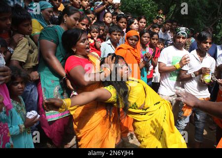 An Indian Hindu devotee dances after piercing a steel rod through his ...