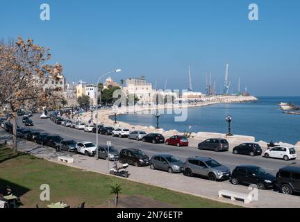 BARI, ITALIEN - 30. OKTOBER 2021: Uferpromenade der Lungomare Imperatore Augusto Straße in Bari, Italien mit Hafen im Hintergrund Stockfoto