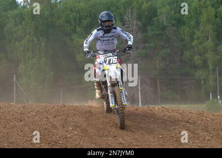 SHARYA, RUSSLAND - 06. AUGUST 2022: Moto Racer auf einem Motocross-Bike auf der Rennstrecke Stockfoto