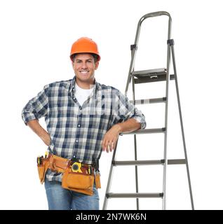 Professioneller Baumeister in der Nähe von Metallleiter auf weißem Hintergrund Stockfoto