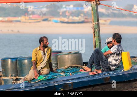 Diu, Indien - Dezember 2018: Fischer, die auf einem Fischerboot in den Gewässern vor der Küste der Insel Diu unterwegs sind. Stockfoto