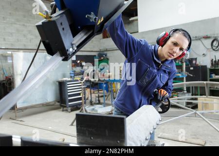 Eine Frau schneidet Stahl mit einem Lötbrenner Stockfoto