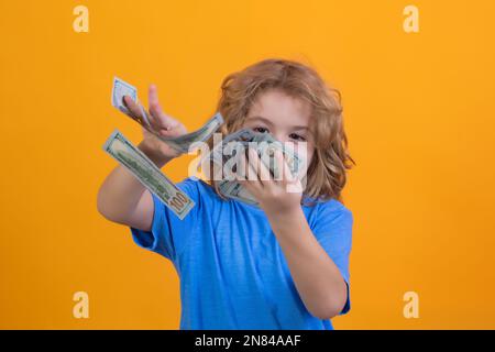 Amerikanische Träume. Der Junge hat viele hundert Dollar isoliert auf gelbem Hintergrund. Stockfoto