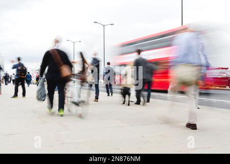 Bild von Menschenmassen von Pendlern, die über eine Brücke in London, Großbritannien, laufen Stockfoto