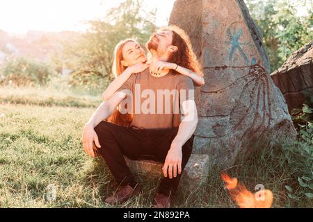 Hipster, romantisches Paar, das Spaß im Park hat. Genießen Sie die Nachmittagssonne. Lockiges Haar Freund mit langhaarigen Freundin. Stockfoto