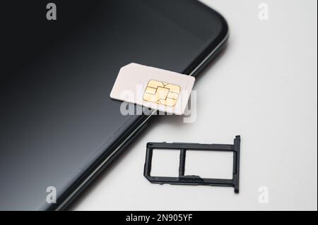 Austausch der SIM-Karte im Telefon. Mobile Simcard Stockfoto