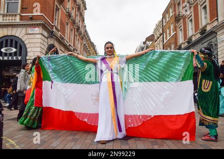 London, Großbritannien. 11. Februar 2023 Ein Demonstrant tritt mit iranischen Flaggen-„Flügeln“ auf. Eine Gruppe von Frauen inszenierte eine Aufführung in Covent Garden, um gegen das iranische Regime und die Hinrichtungen im Iran zu protestieren und um die Freiheit des Iran zu unterstützen. Stockfoto