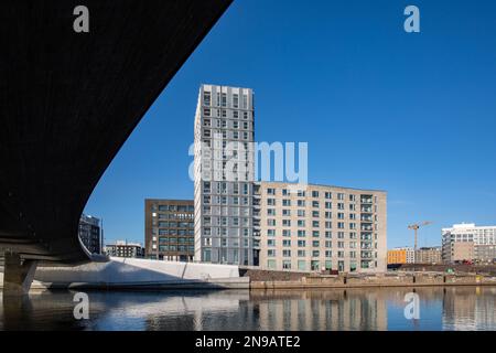 Blick aus dem niedrigen Winkel auf die Atlantinsilta-Brücke und neu gebaute Wohngebäude in Jätkäsaari oder im Bezirk Länsisatama in Helsinki, Finnland Stockfoto