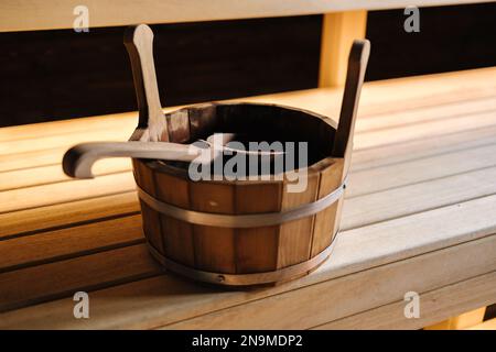 Nahaufnahme verschiedener Saunazubehör in einer Holzsauna. Finnischer Saunaraum mit Trockendampf Stockfoto