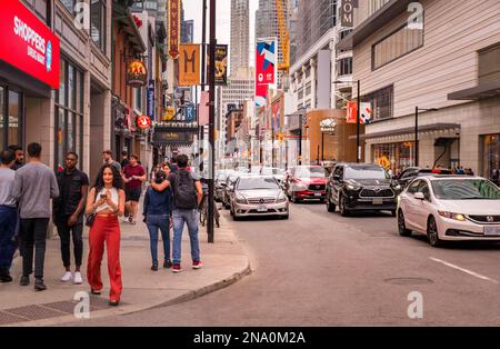 Toronto, Kanada - 07 01 2022: Sommerblick entlang der Yonge Street im Zentrum von Toronto mit Menschen, die auf Gehwegen gehen und Autos in Schlange stehen Stockfoto