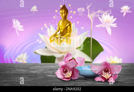 Komposition mit Schwelräucherstab auf dem Tisch und Buddha-Figur im Hintergrund Stockfoto