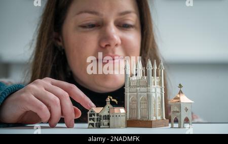 Scottish Gallery, Edinburgh, Schottland. Vicky Ambery-Smith Ausstellung von Silberwerken. Vicky Ambery-Smith ist eine Schmuck- und Silberdesignerin, die Architektur als Inspiration nutzt. Ihre Arbeit wird derzeit auf einer neuen Ausstellung gezeigt, die bis zum 25. Februar 2023 in der Scottish Gallery in Edinburghs Neustadt stattfindet. Das Bild zeigt Kirsty Sumerling aus der Scottish Gallery, mit einem Blick auf die vier aufwendigen Silberstücke des Gebäudes, einschließlich Shakespeare Globe Theatre (links), Magdalen Tower Box, 2015 (Mitte) und Scottish Doocot Lapel Pin - inspiriert von Bowerbutts II, 2018 Picture Phil Wilki Stockfoto