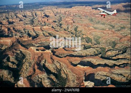 Ein kleines Flugzeug fliegt über dem Canyonlands-Nationalpark, Utah, USA Stockfoto