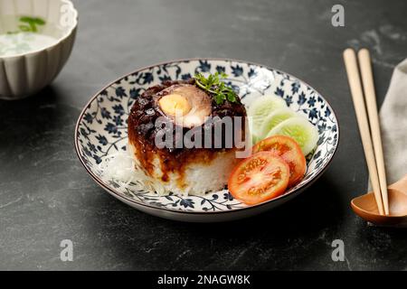 Köstliche Sojasauce, Hühnchen und Reis, gedünstet in Claypot, serviert mit Suppe Stockfoto