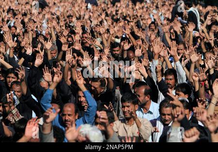 Shiite Muslims chant religious slogans during a Muharram procession, in ...