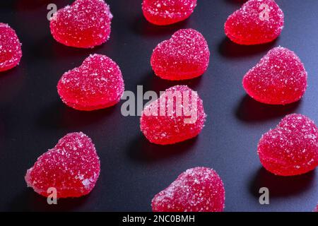 Schöner Valentinstag mit roten Herzen auf schwarzem Hintergrund Stockfoto