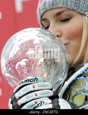 Lindsey Vonn of U.S. kisses her trophy of the women's World Cup downhill discipline title, at the World Cup finals in Lenzerheide, Switzerland, Wednesday, March 16, 2011. (AP Photo/Giovanni Auletta)