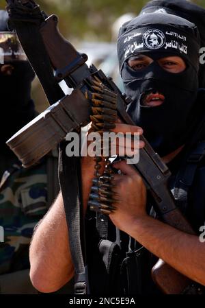 A Palestinian militant member of the Qassam Brigades, Hamas' armed wing ...