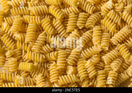Rohe, trockene, organische Fusilli-Pasta in einer Schüssel Stockfoto