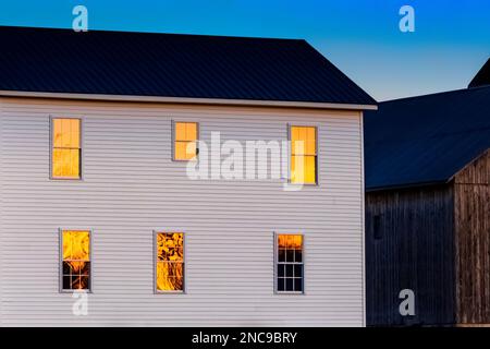 Amish Farmhouse Fenster reflektieren die untergehende Sonne in Mecosta County, Michigan, USA [Keine Veröffentlichung von Immobilien; nur redaktionelle Lizenzierung] Stockfoto