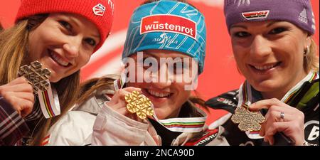 Elisabeth Goergl, of Austria, center, winner of the women's super-G race, poses on the podium with silver medal winner Julia Mancuso, of the United States, left, and bronze medal winner Maria Riesch, of Germany, at the Alpine World Skiing Championships in Garmisch-Partenkirchen, Germany, Tuesday, Feb. 8, 2011. (AP Photo/Matthias Schrader)